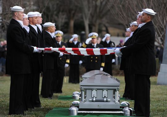 Navy pallbearers remove flags from the caskets of two sailors from the USS Monitor for interment at Arlington National Cemetery.(H. Darr Beiser, USA TODAY)